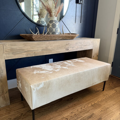 Modern rustic cowhide upholstered bench built with 2x4s and free plans.