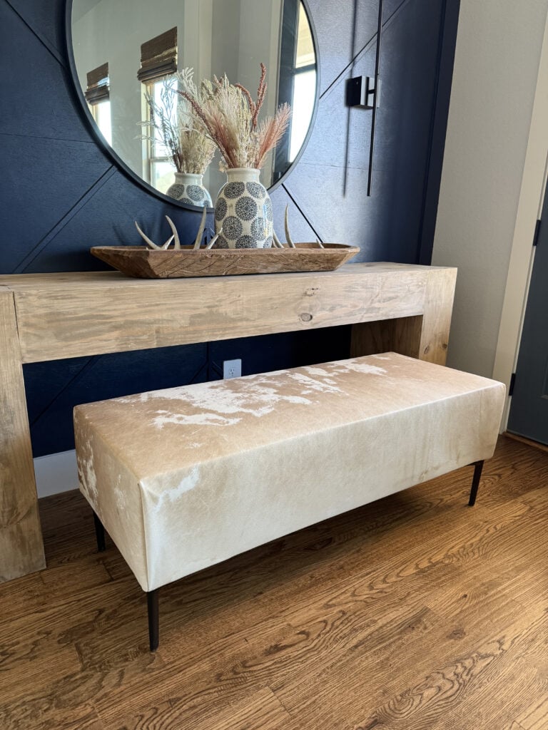 Modern rustic cowhide upholstered bench built with 2x4s and free plans.