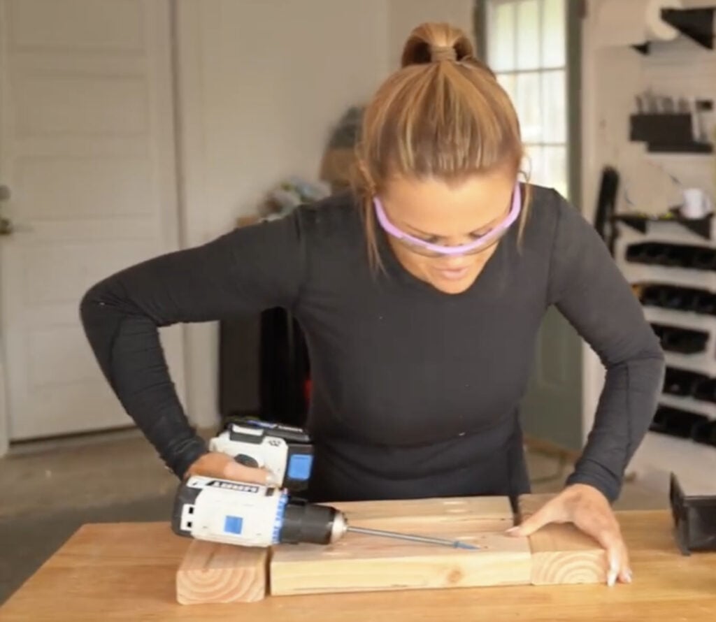 Building the side frame assembly for a DIY cowhide bench using 2x4 lumber.